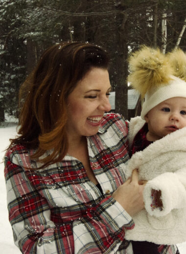 Woman holding baby in the snow