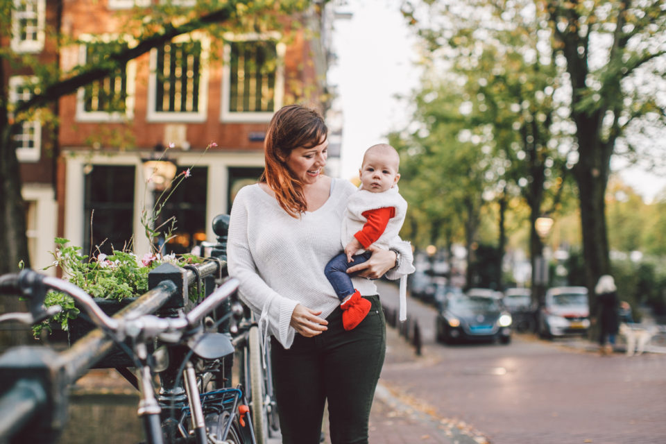 Woman walking holding baby