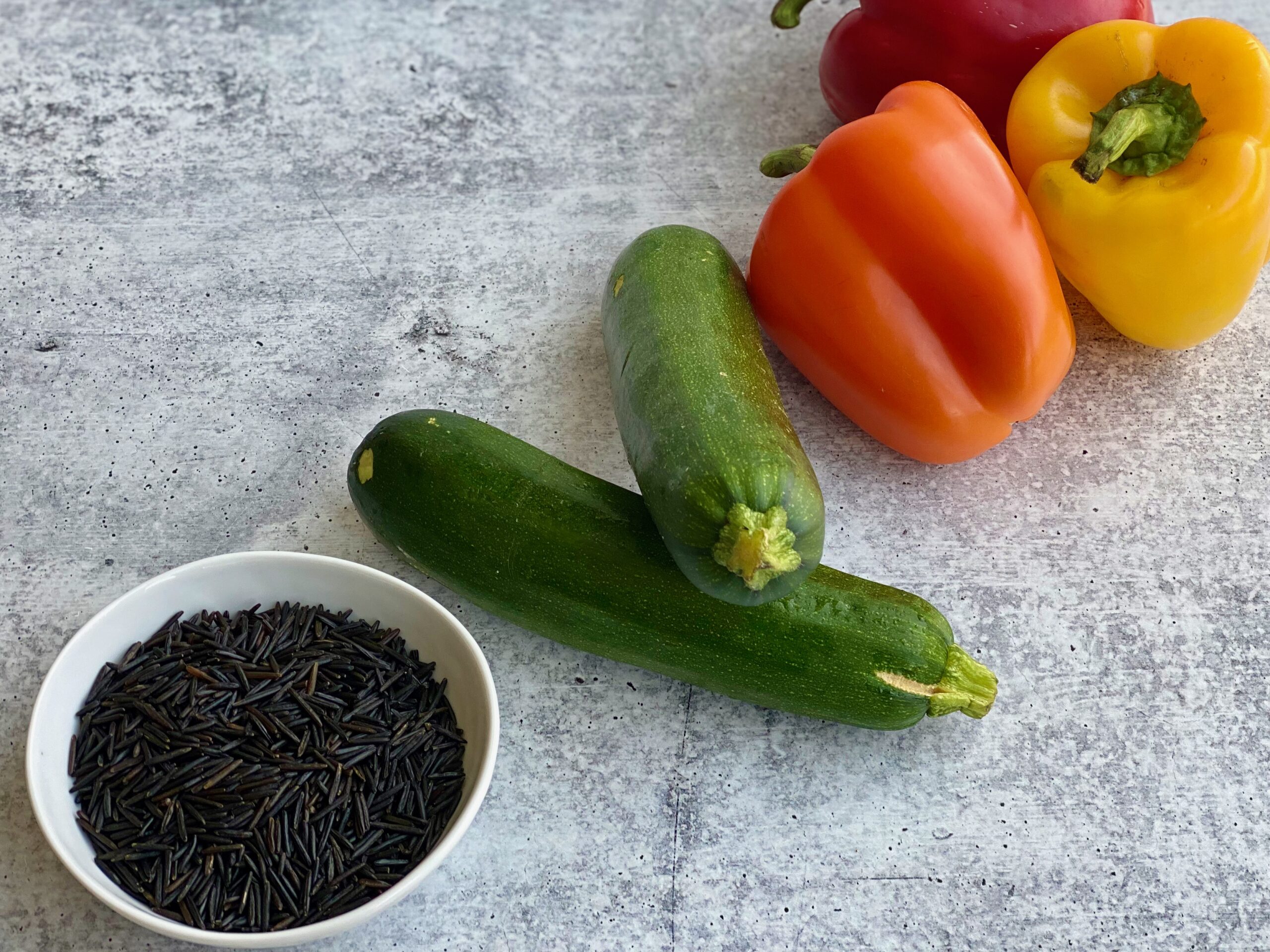 An image of rice, zucchini and bell peppers