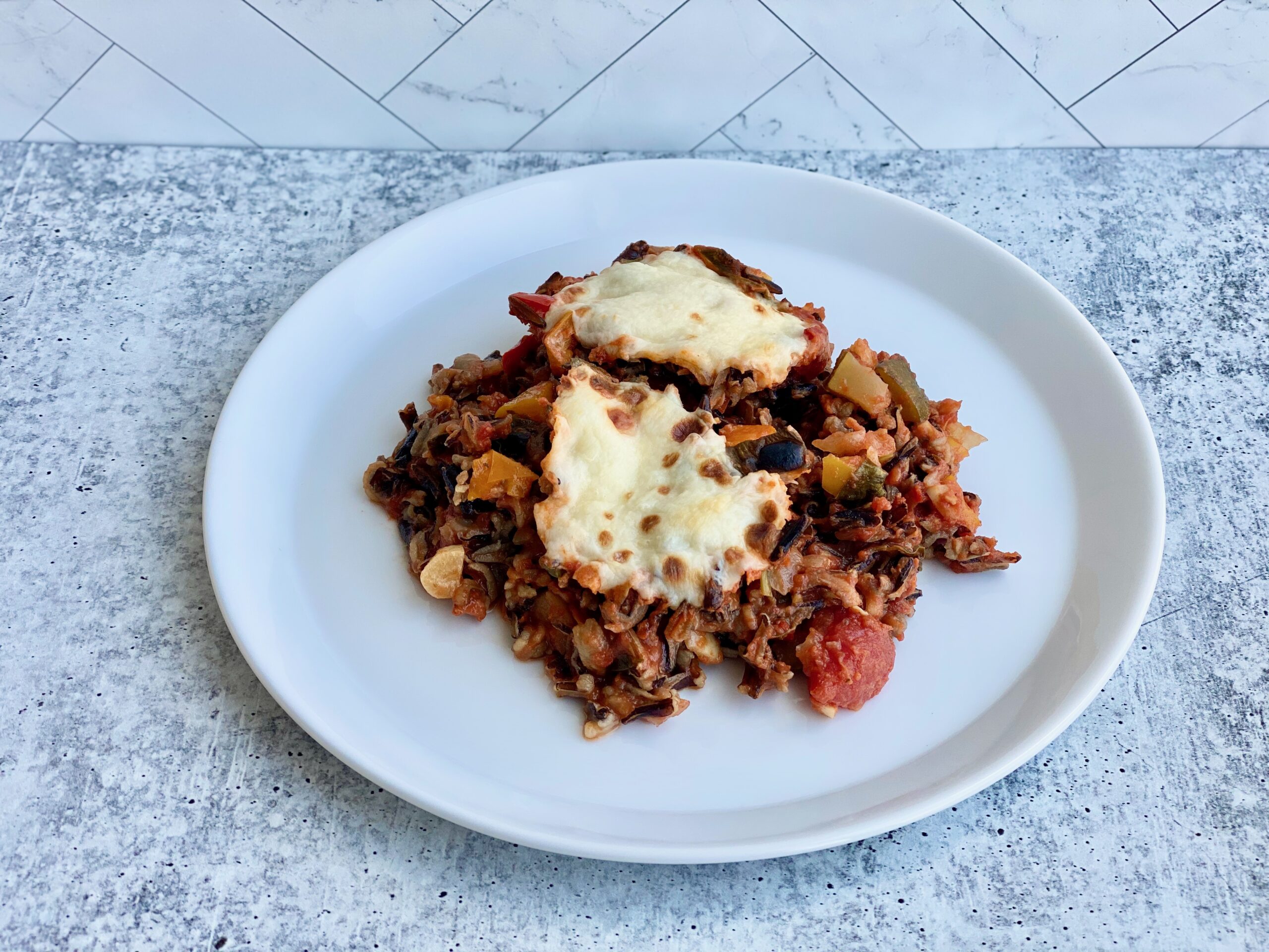 An image of a plate topped with stuffed bell peppers