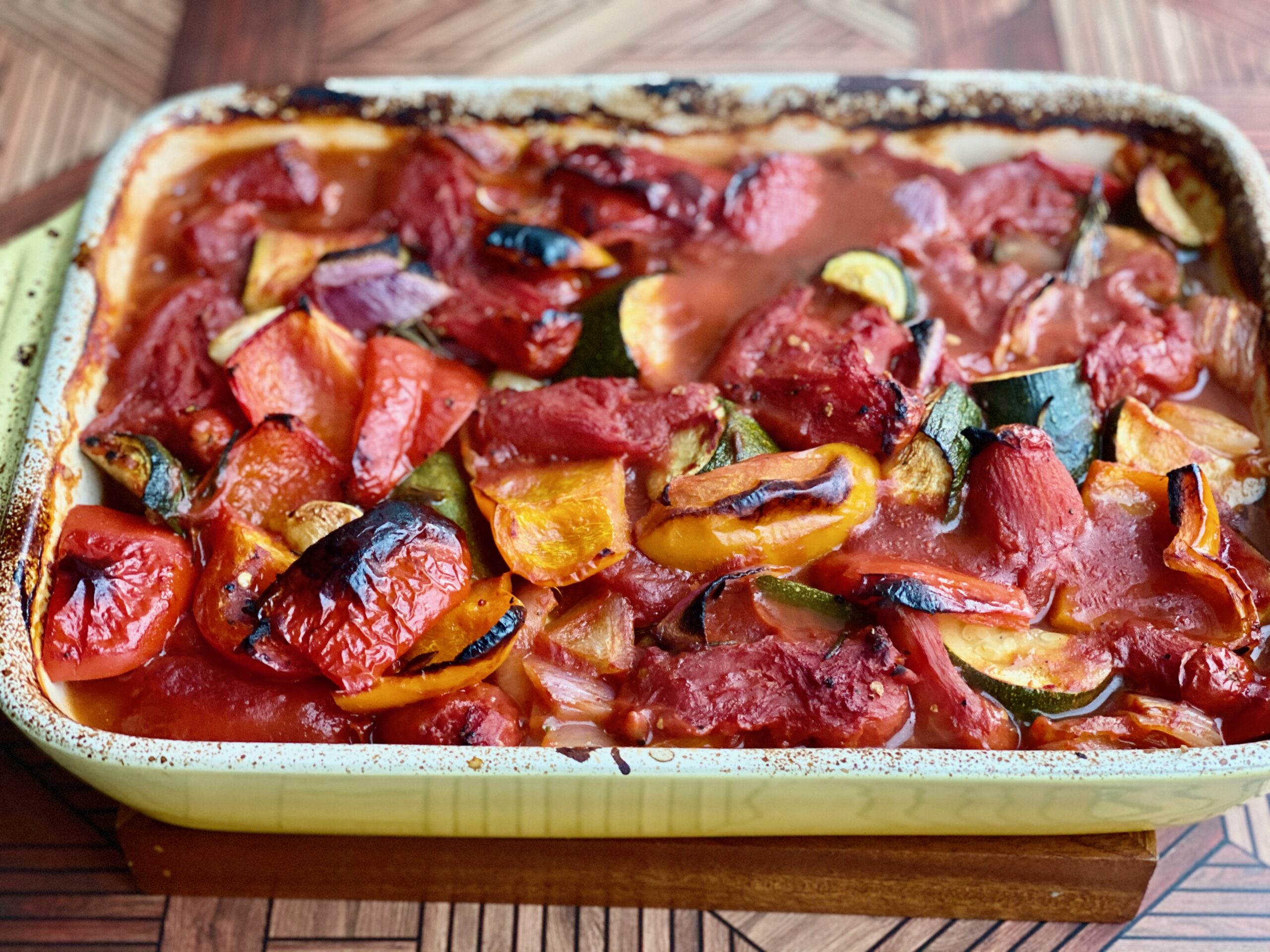 An image of a pan full of charred, roasted vegetables