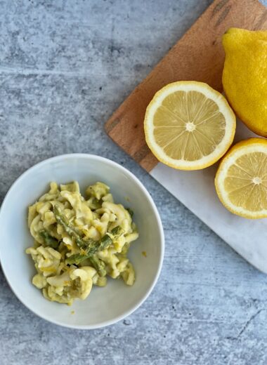 Picture of a bowl of pasta with asparagus and lemons