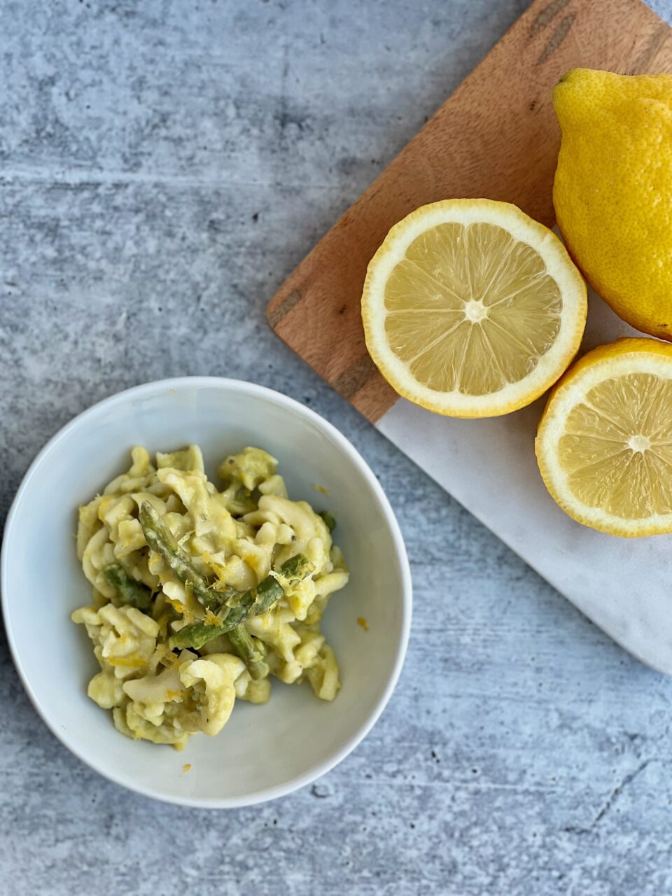 Picture of a bowl of pasta with asparagus and lemons