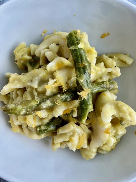 Picture of a bowl of pasta with asparagus and lemons