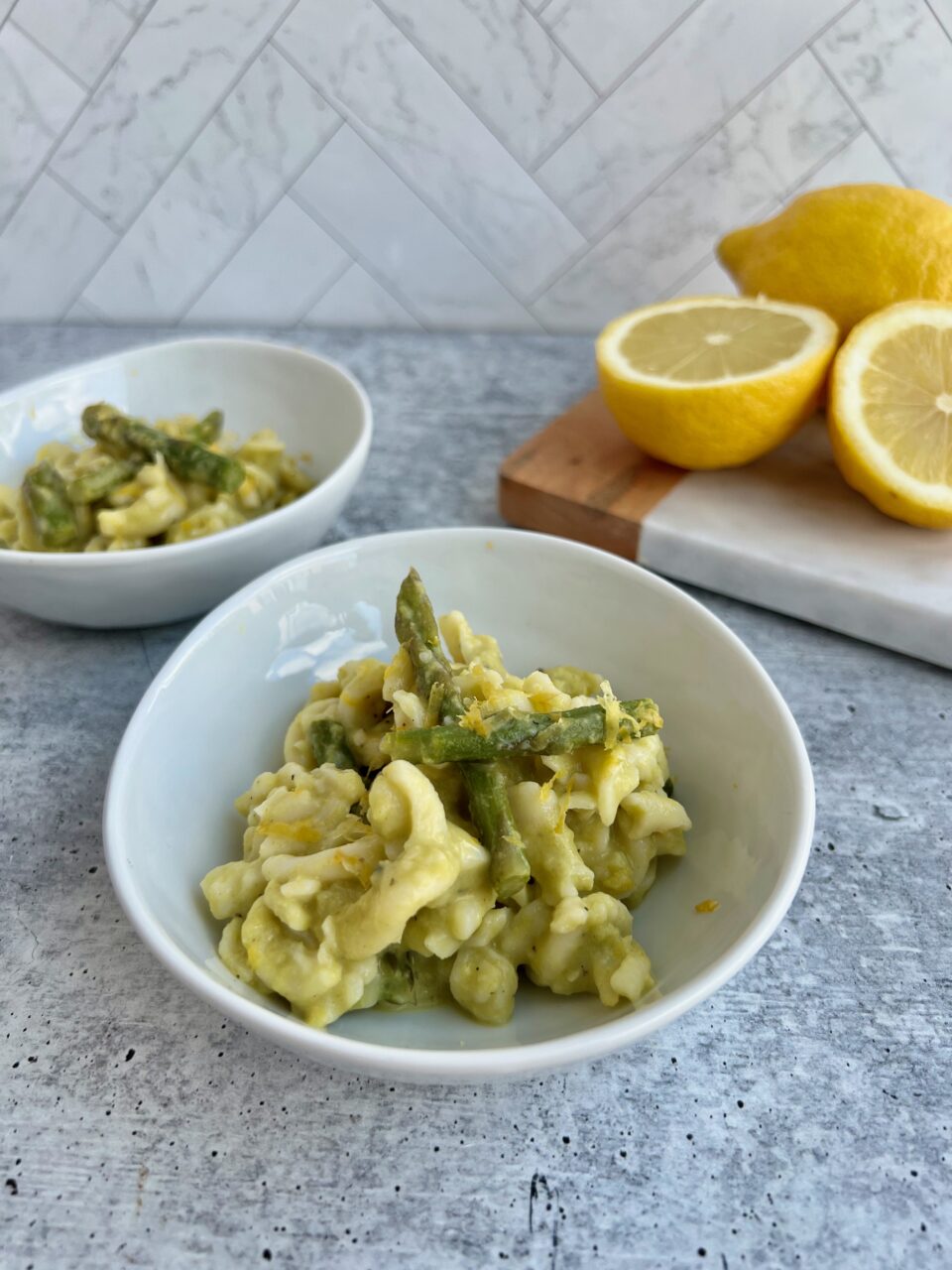 Picture of a bowl of pasta with asparagus and lemons