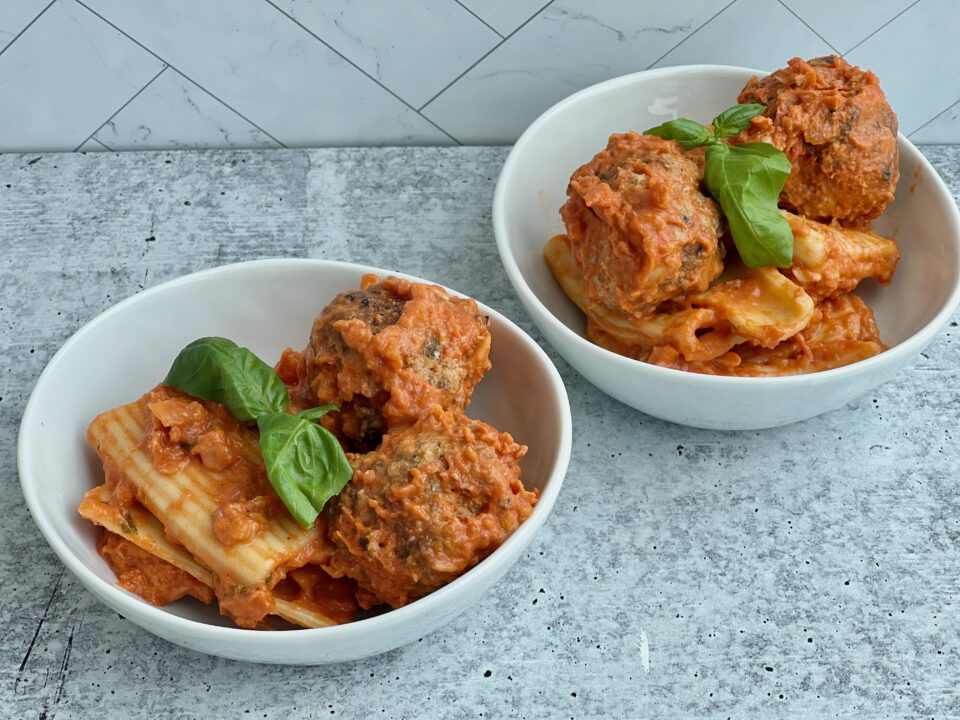Two bowls with pasta and meatballs