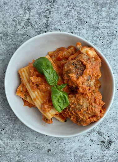 A bowl with pasta and meatballs